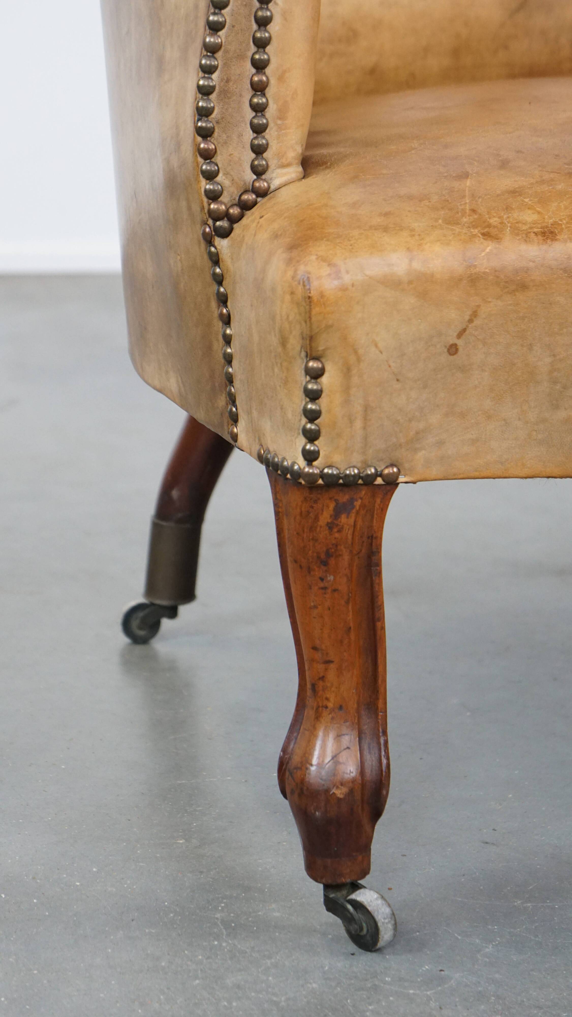 Antique sheep leather club chair/armchair on wheels