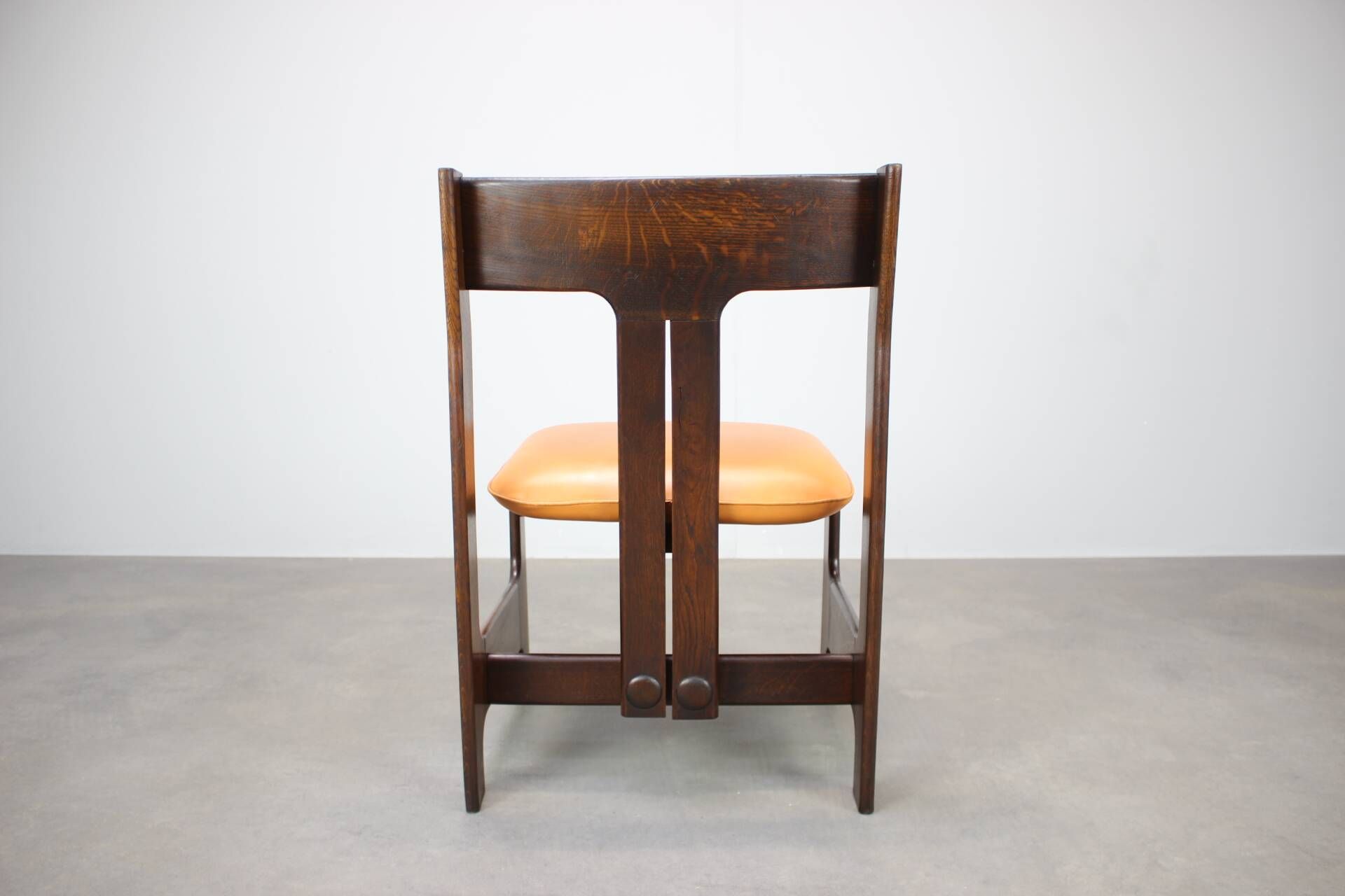 Vintage German sculptural chair from the 1970s in wood with orange faux leather.