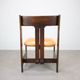 Vintage German sculptural chair from the 1970s in wood with orange faux leather.