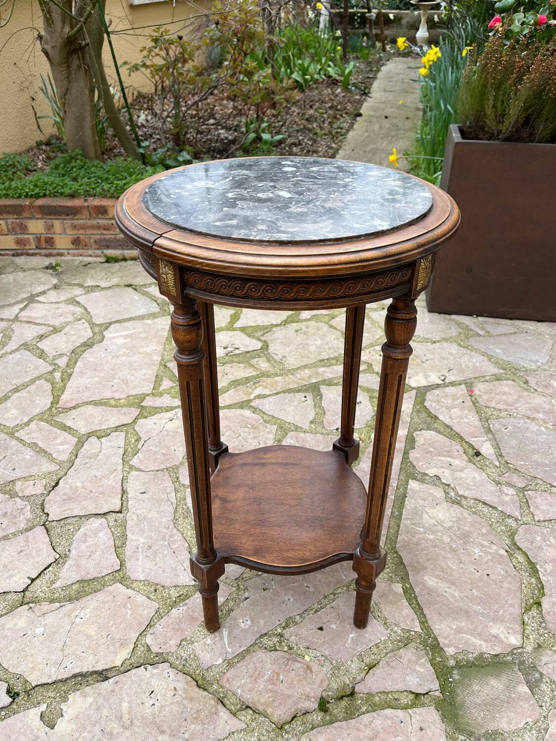 Old wooden pedestal table with marble top