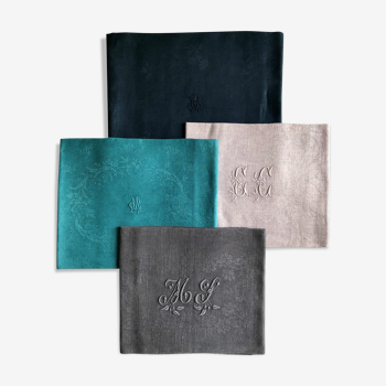 Set of four old damasked and monogrammed napkins, dyed in multiple colors