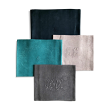 Set of four old damasked and monogrammed napkins, dyed in multiple colors