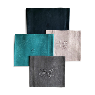 Set of four old damasked and monogrammed napkins, dyed in multiple colors