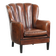 Fauteuil en peau de mouton confortable au design unique, fini avec un passepoil noir.