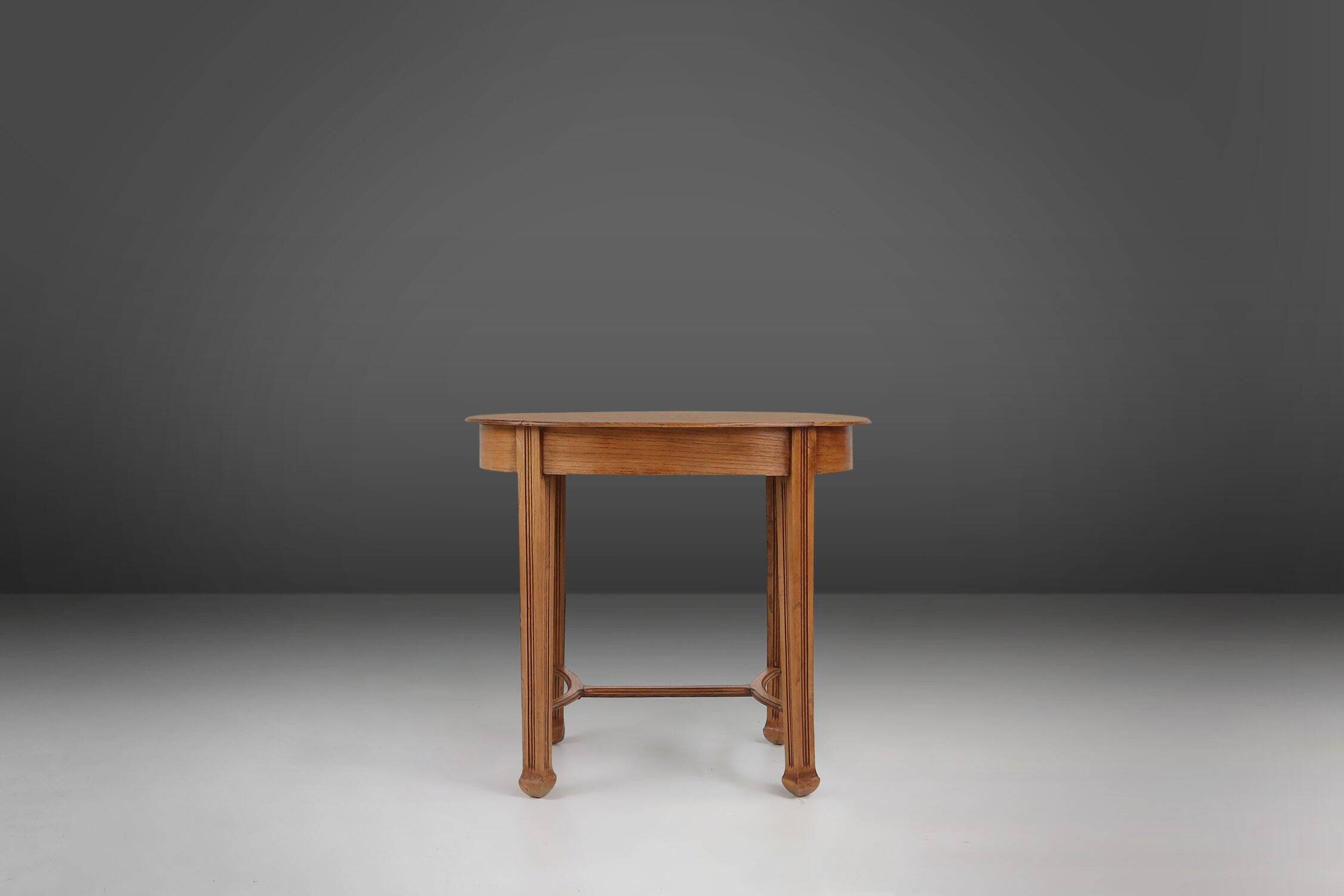 Timeless French Art Deco carved oval side table in oak, 1930s