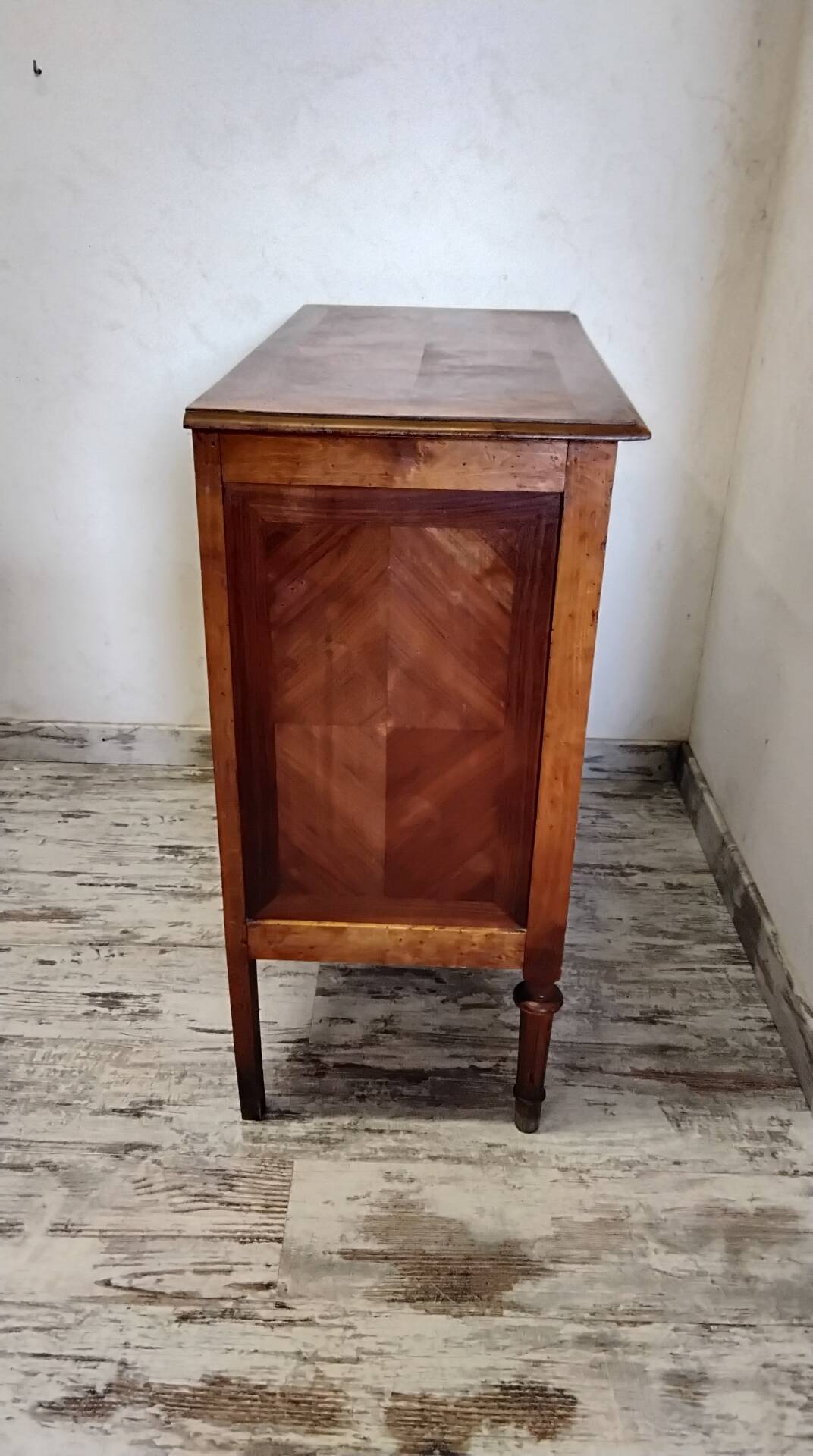 Antique marquetry commode in the Louis XVI style.