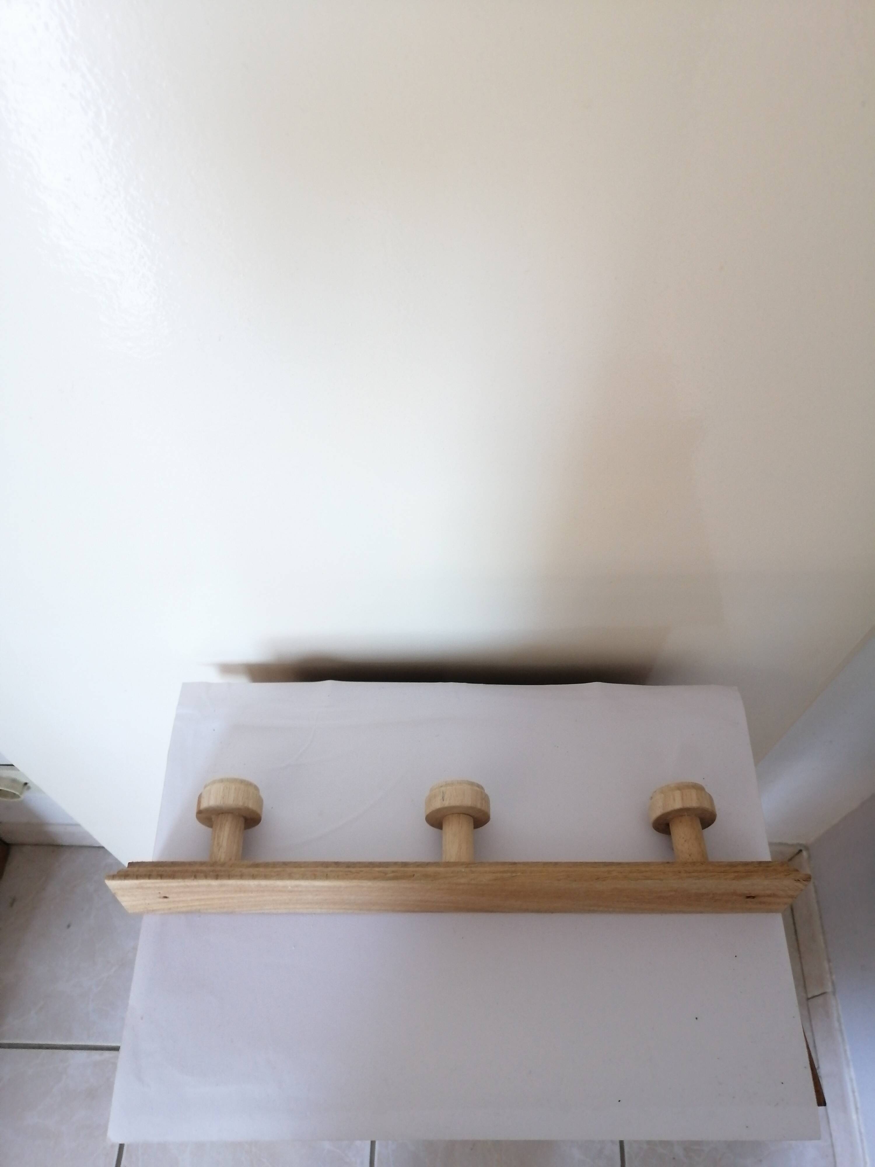 Old wall coat rack in raw wood