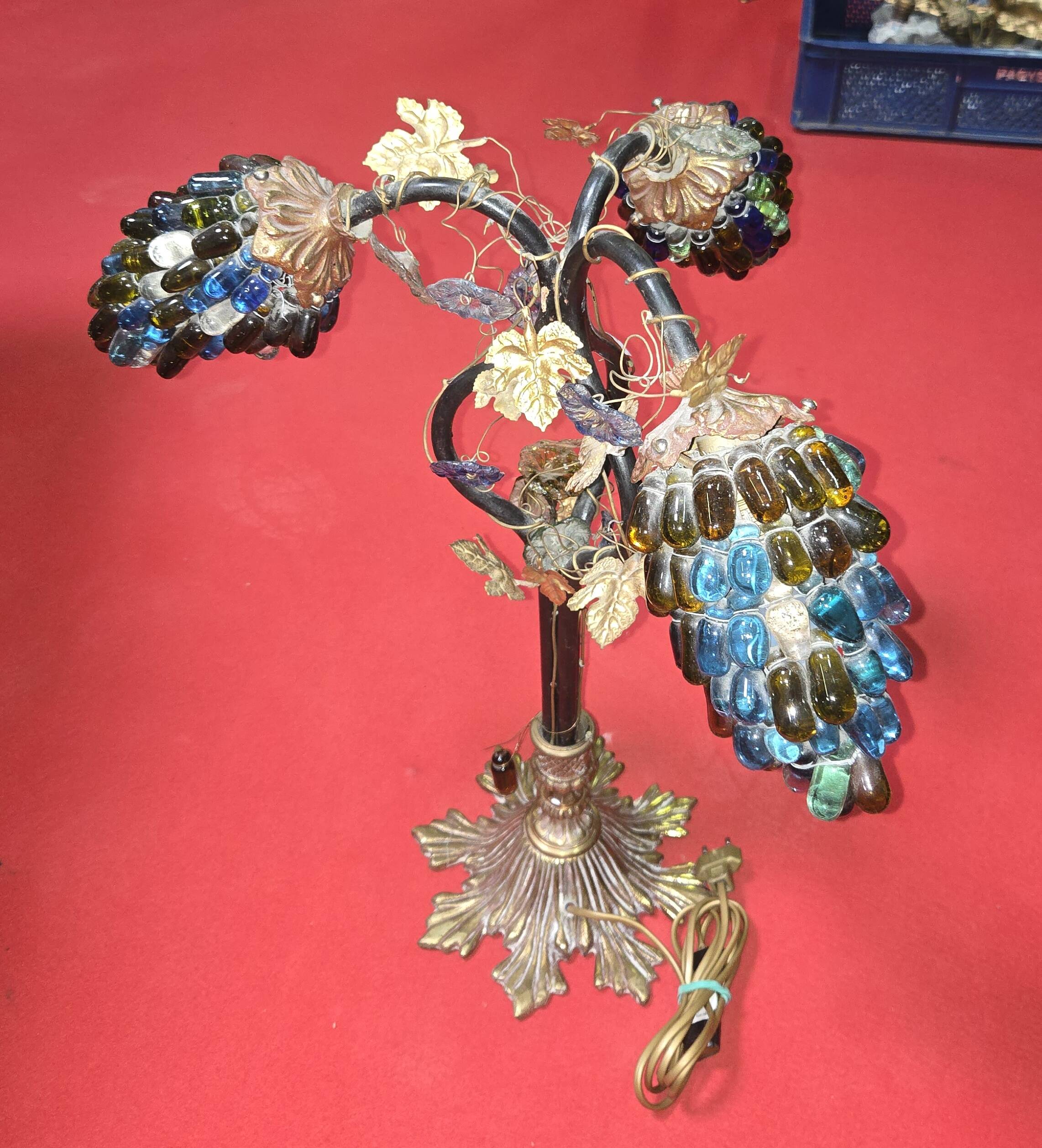 Decorative table lamp in the shape of coloured glass grape clusters.