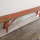 Orange folding wooden bench