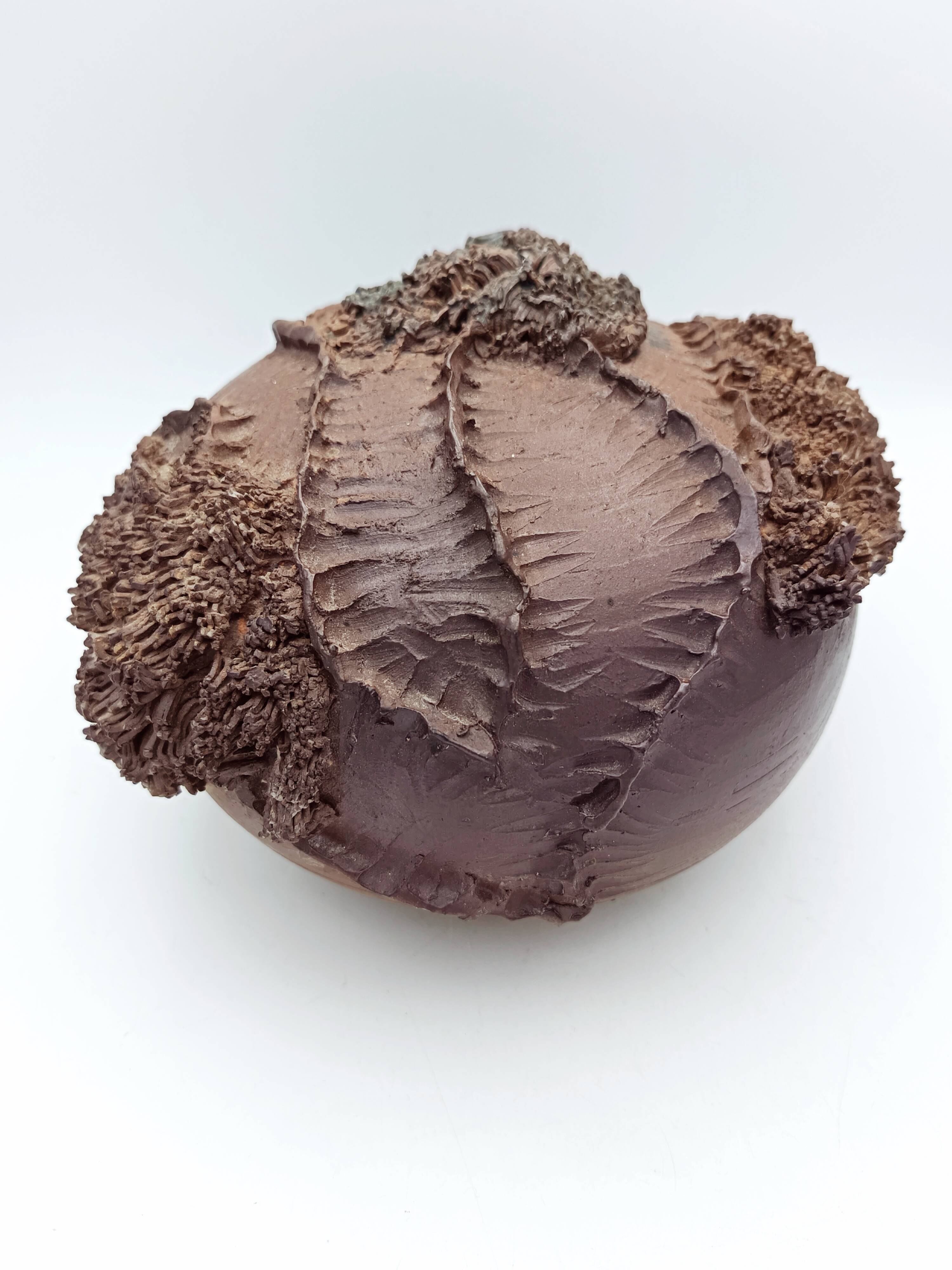 Ceramic vase with organic plant decoration