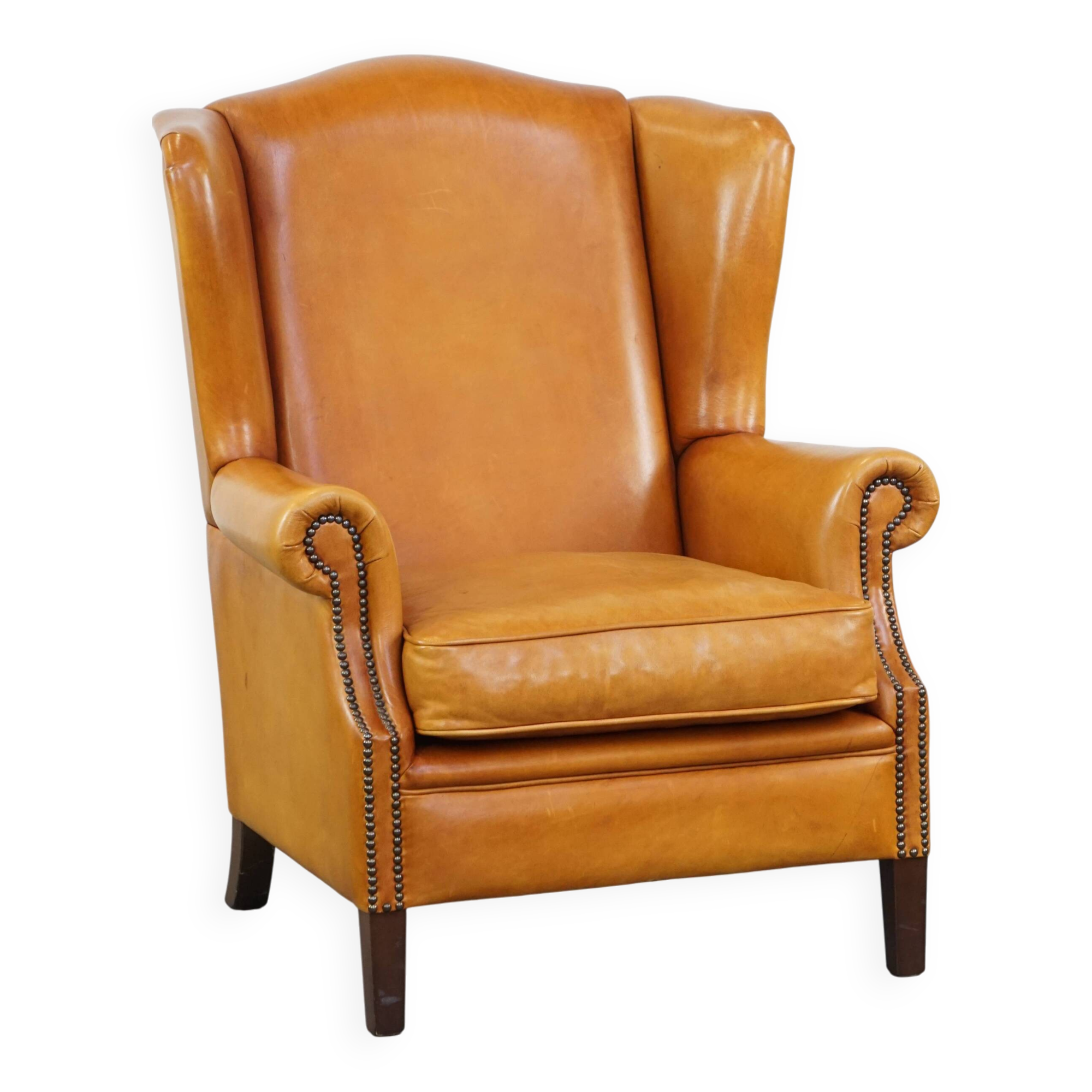Cow leather wingback chair finished with decorative nails