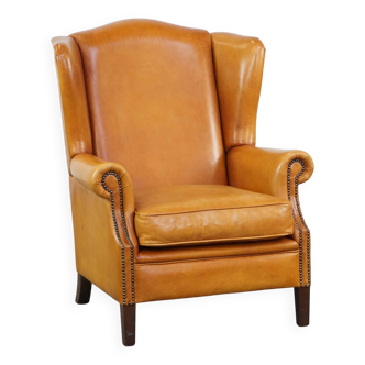 Cow leather wingback chair finished with decorative nails