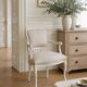 Louis XV style armchair in patinated beige, upholstered in beige fabric.
