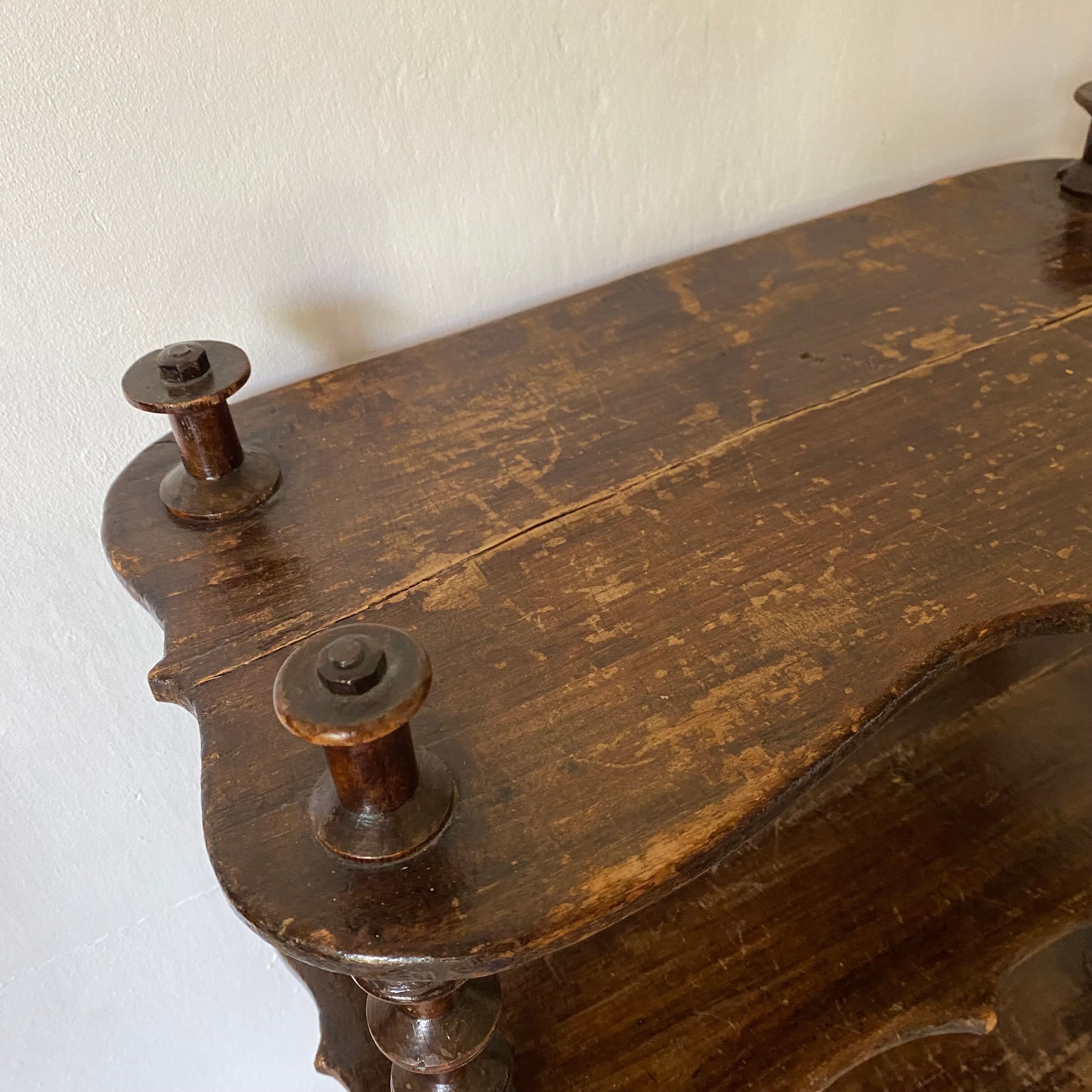 Old shelf in turned wood like reels