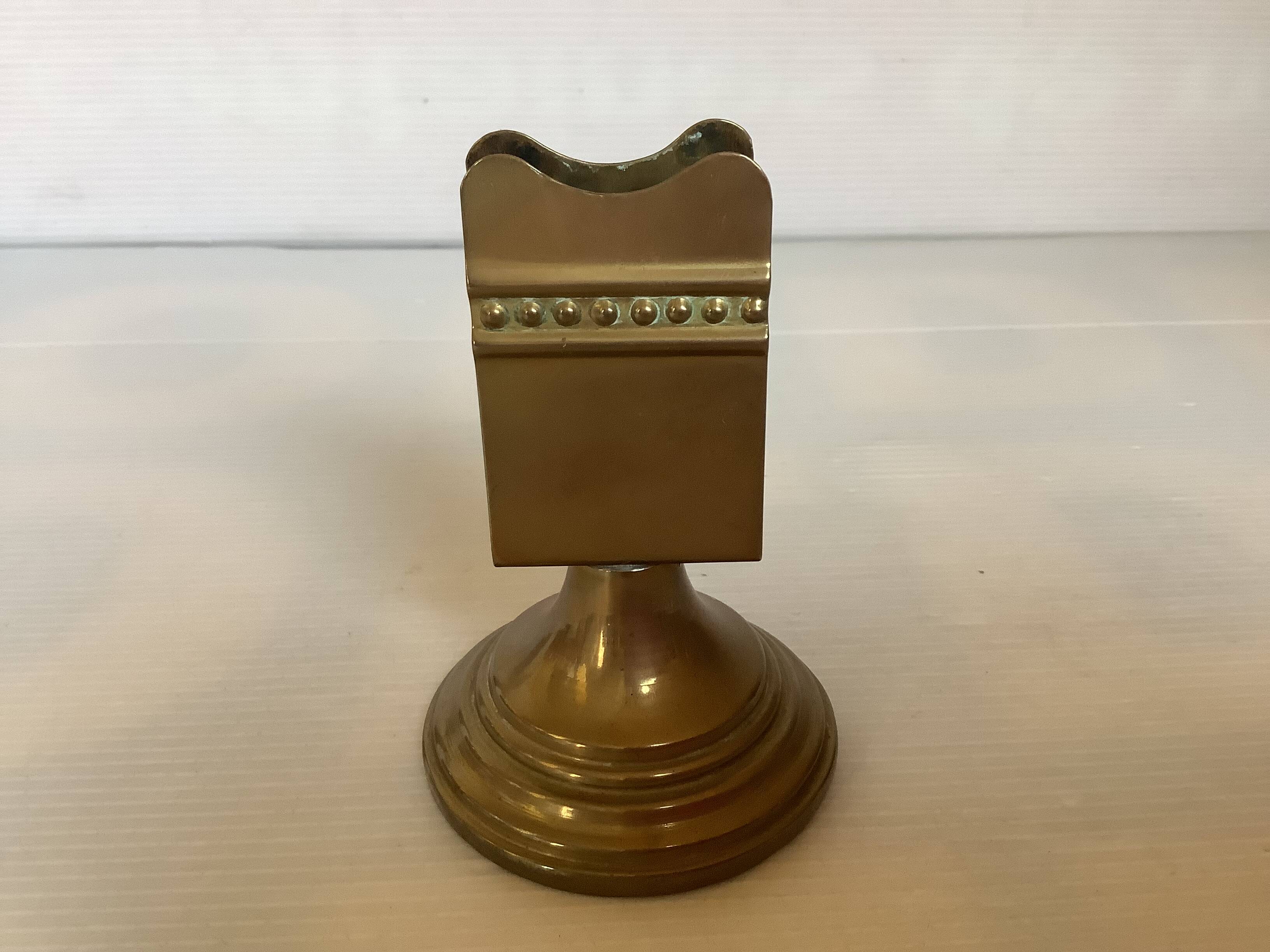 Antique brass match holder with tulip base.