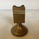 Antique brass match holder with tulip base.