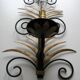 Wrought iron sconces decorated with golden pineapple leaves