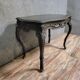 Antique desk in the Louis XV style, resting on four curved legs.