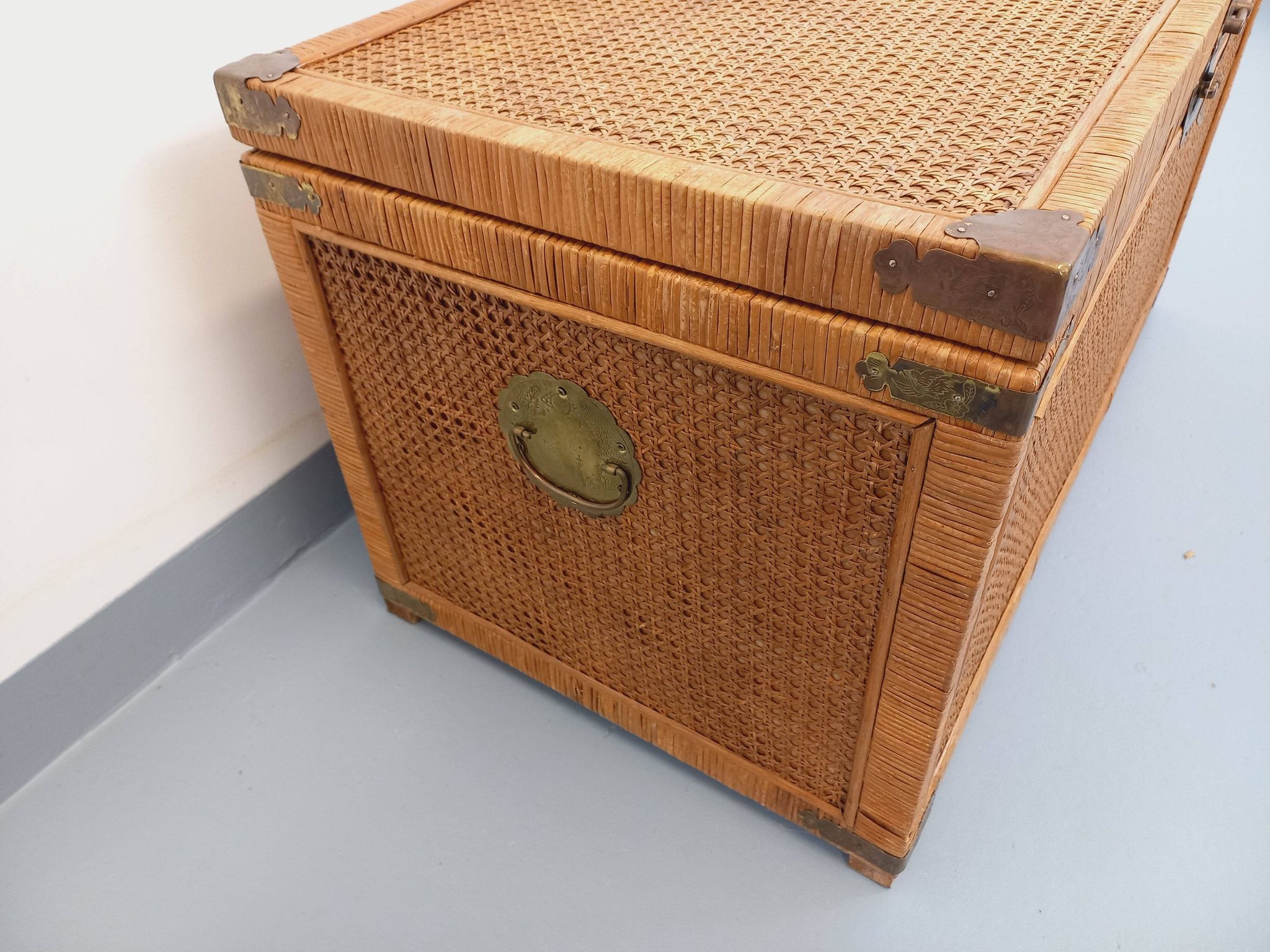 Vintage trunk in wood, rattan, caning, and brass.