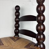 Brutalist wood turned bobbin low rush chair n the style of Charles Dudouyt