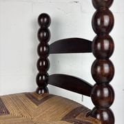 Brutalist wood turned bobbin low rush chair n the style of Charles Dudouyt