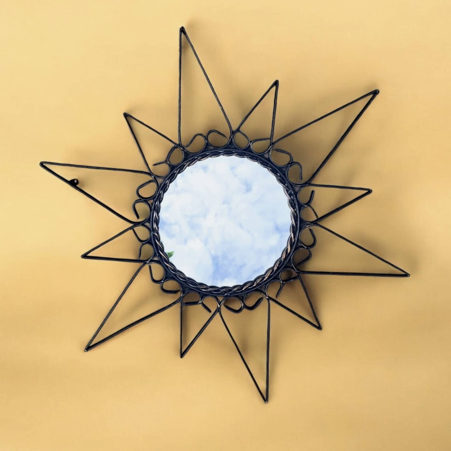 Old wrought metal sun mirror