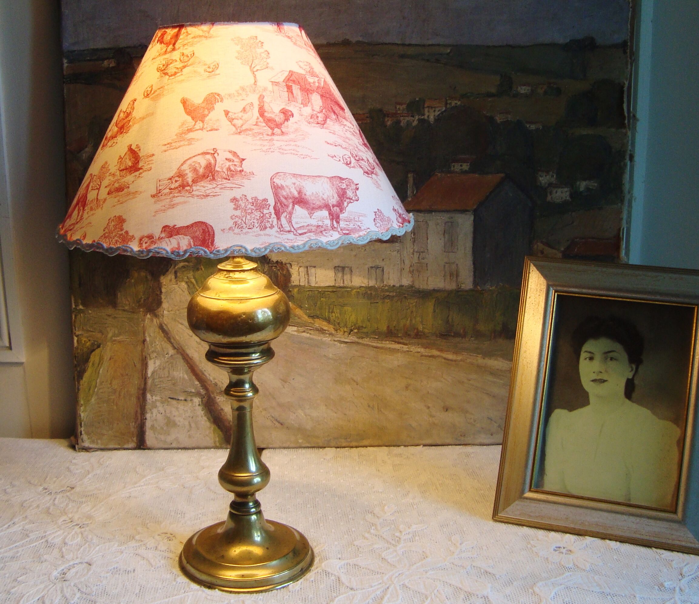 Ancient brass lamp with its youthd shade motifs farm animals