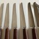 Set de 9 couteaux à manche de bois de palissandre mid century
