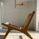 Reclining armchair in natural wood and woven rattan