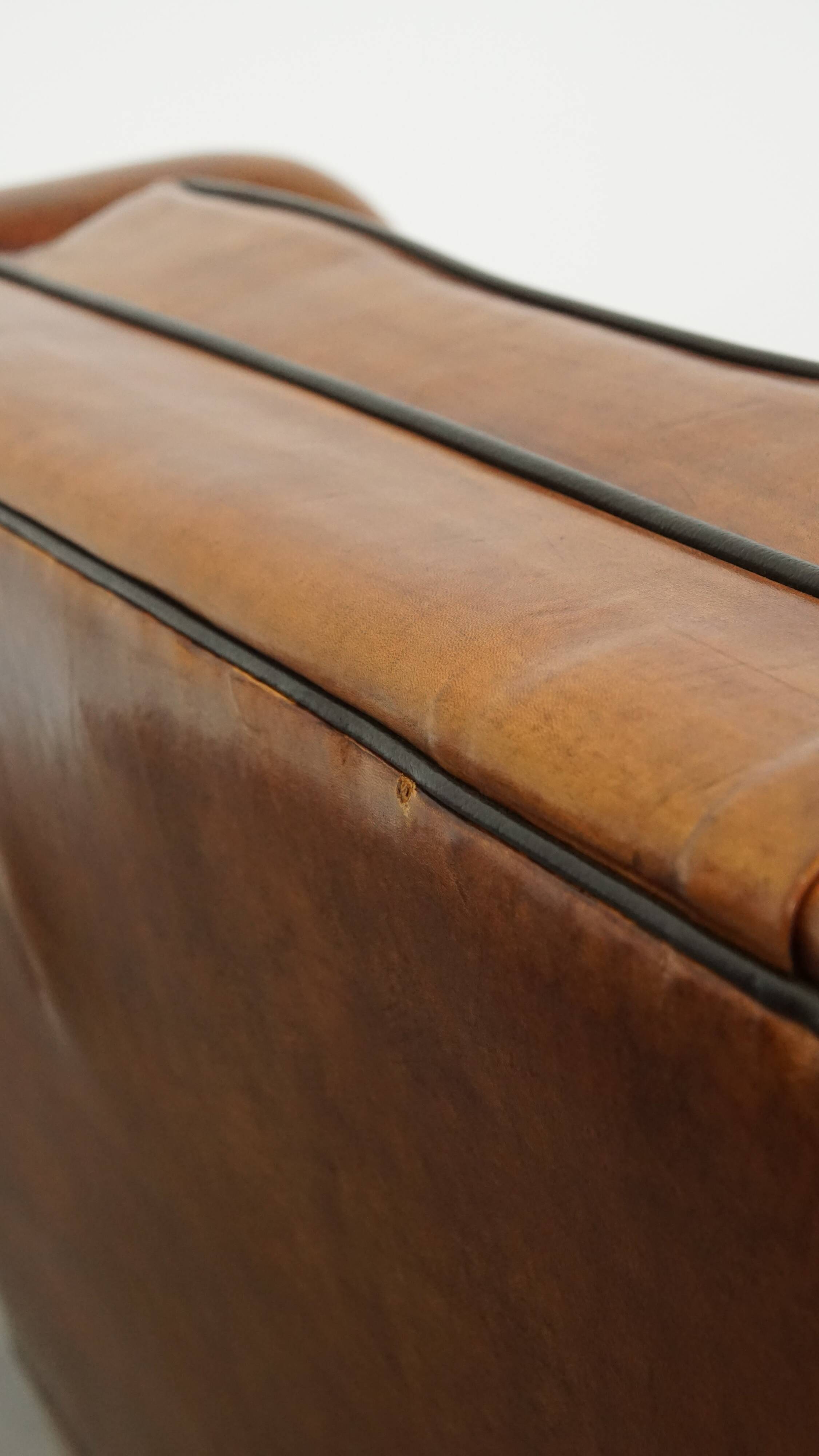 Set of 2 very comfortable large sheepskin armchairs elegantly finished with black piping