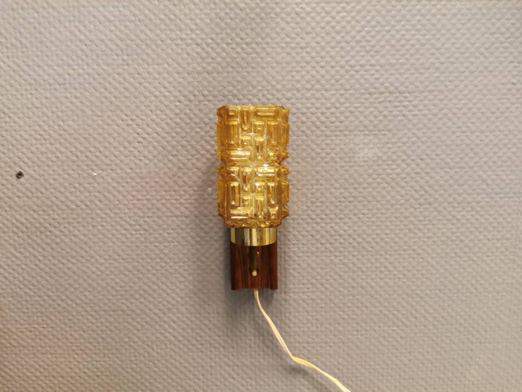 wall lights in rosewood look, with amber coloured glass and brass details.