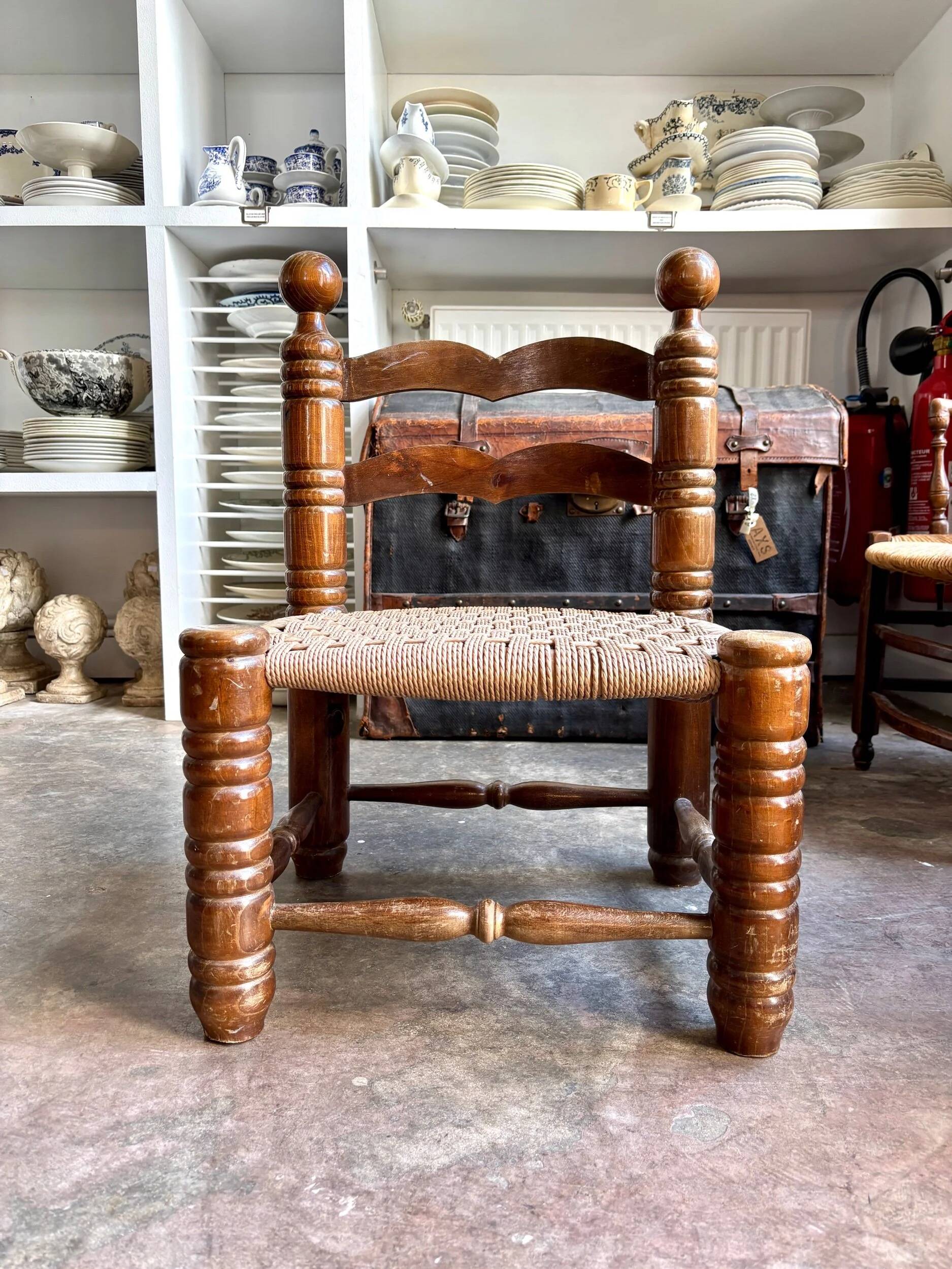 Low chair in dark wood and woven Danish cord attributed to Charles Dudouyt.