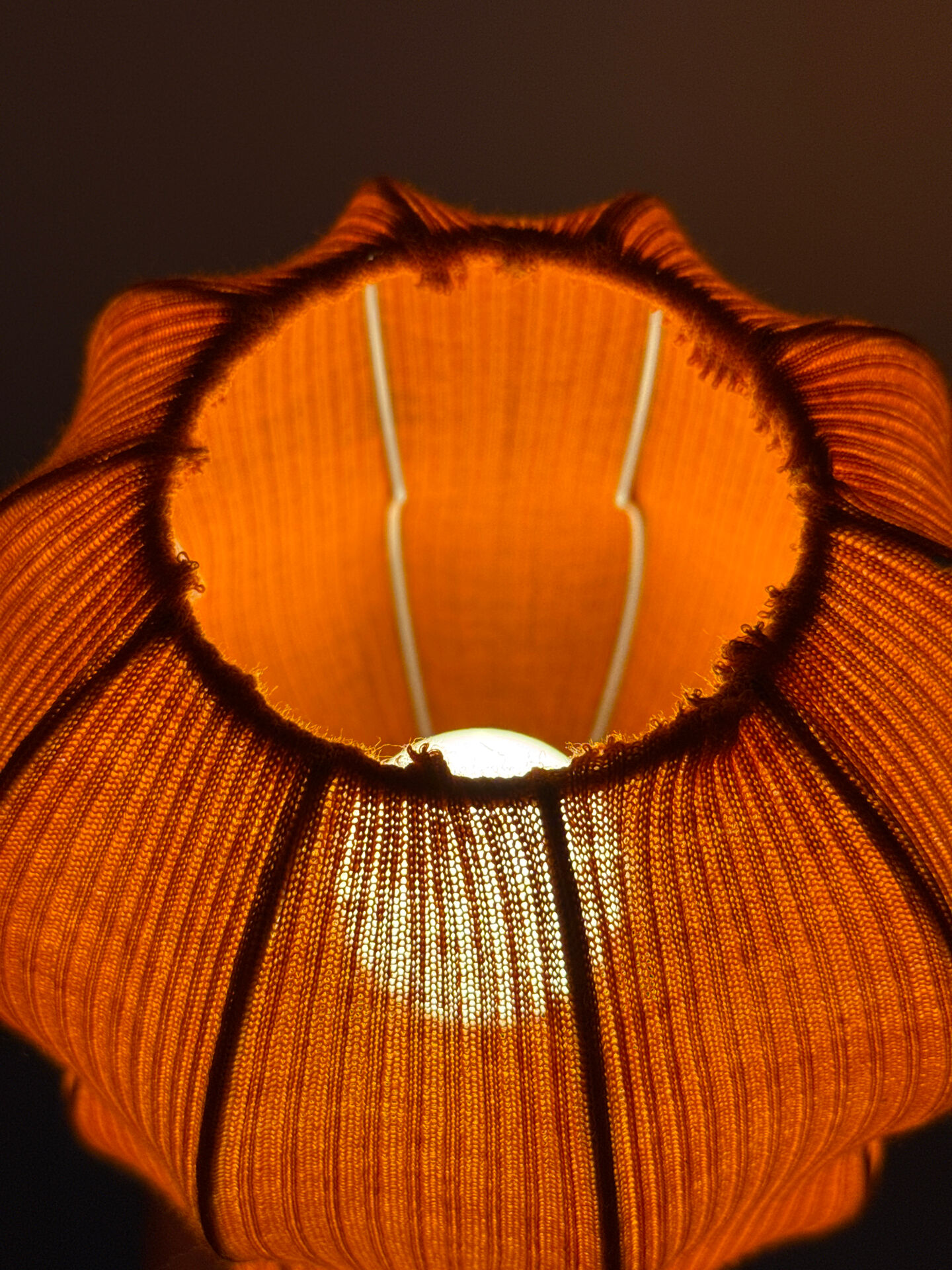 Lamp with a plastic base and a coloured fabric shade in Mid Century style.