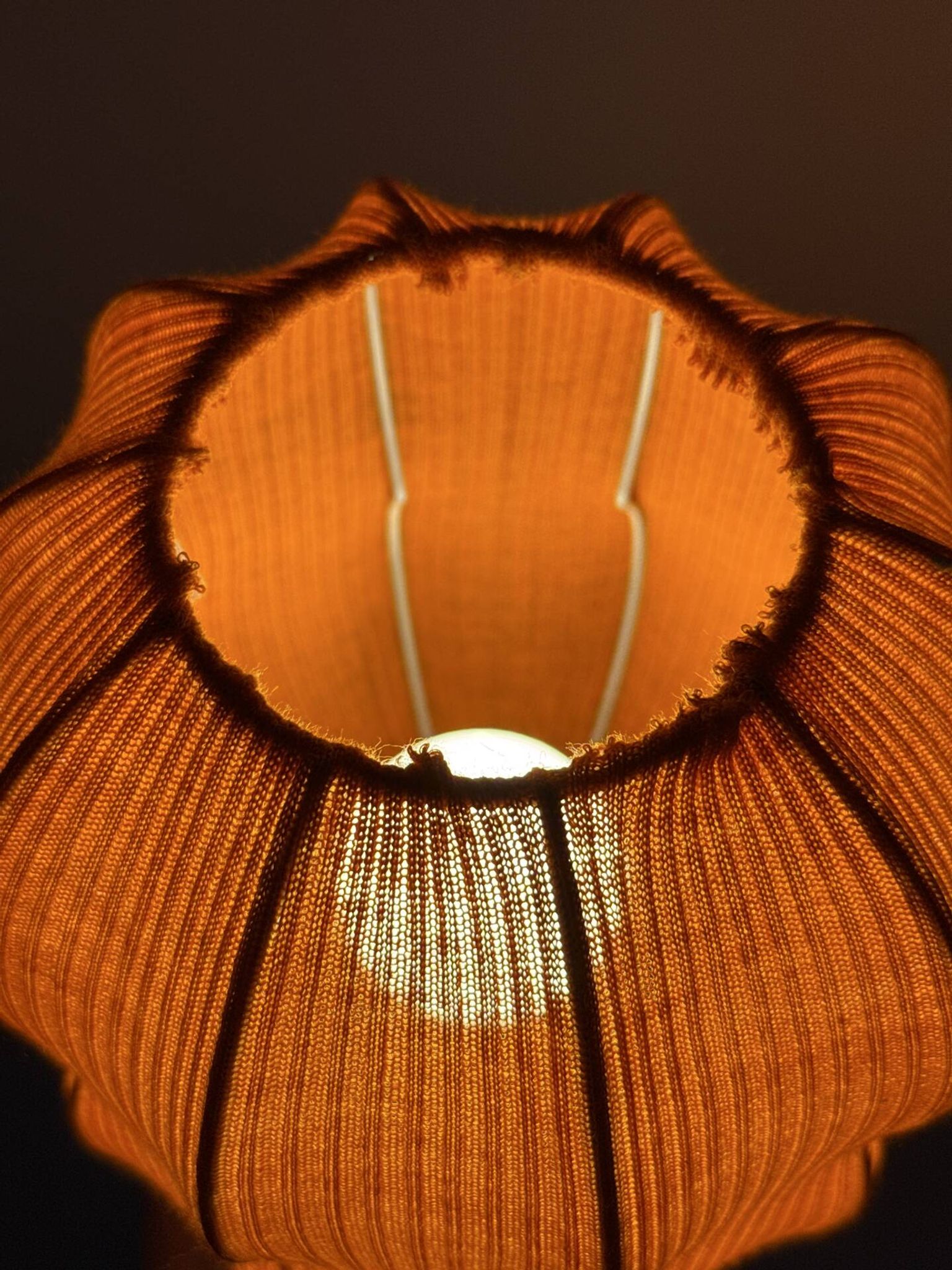 Lamp with a plastic base and a coloured fabric shade in Mid Century style.