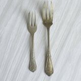 Pair of metal forks, ornate design