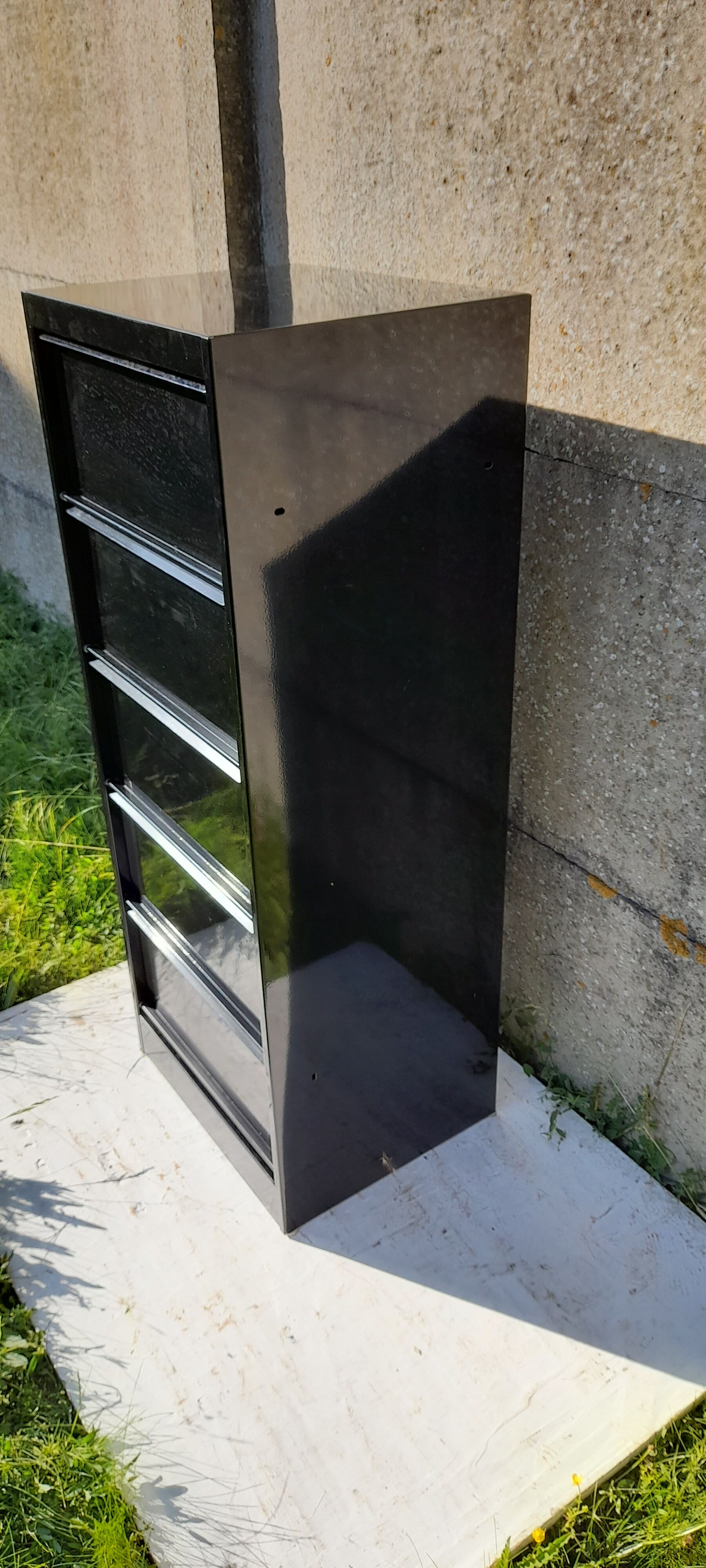 Black metal clamshell cabinet