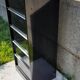 Black metal clamshell cabinet