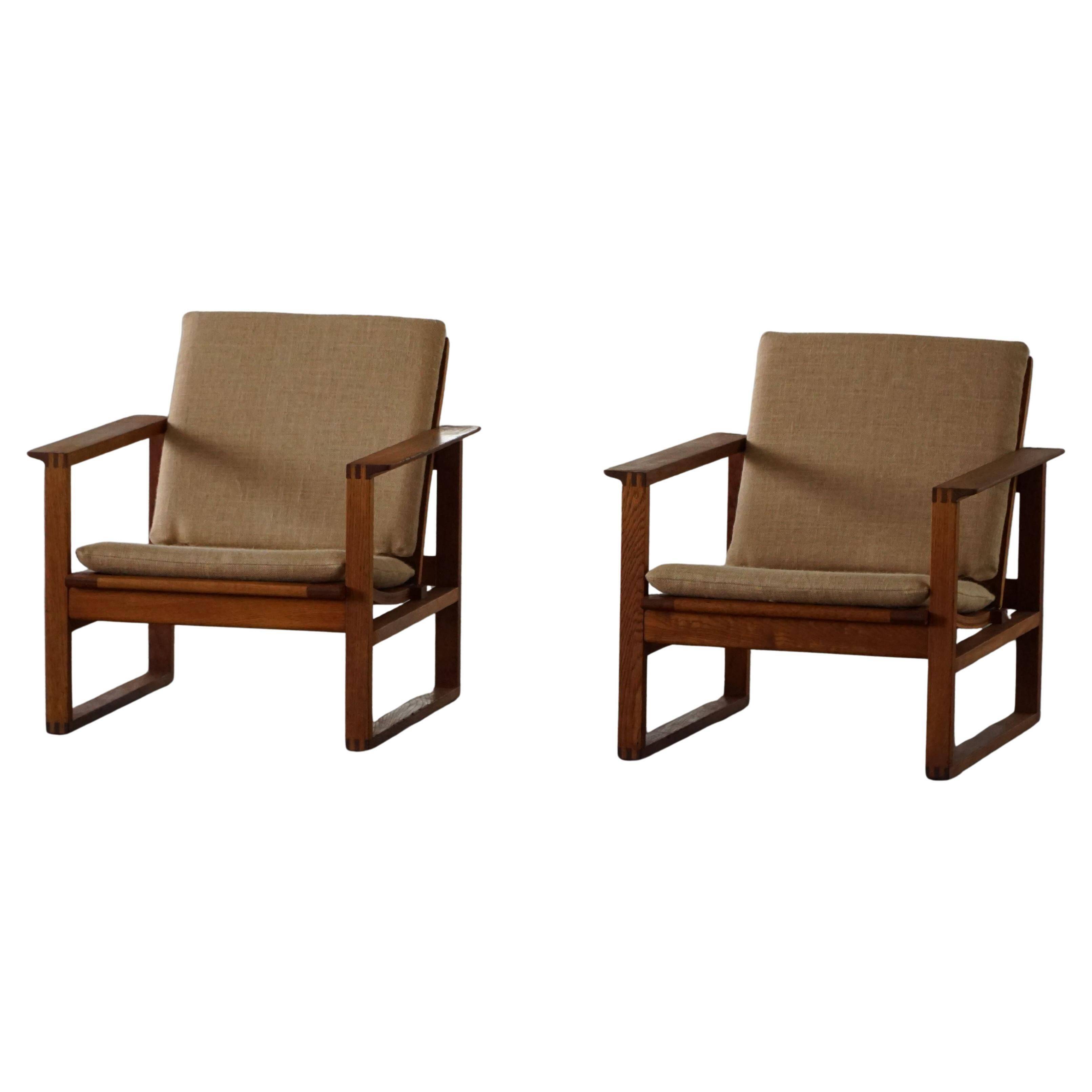 Børge Mogensen, a pair of BM2256 lounge chairs in oak and jute, Denmark, 1960s.