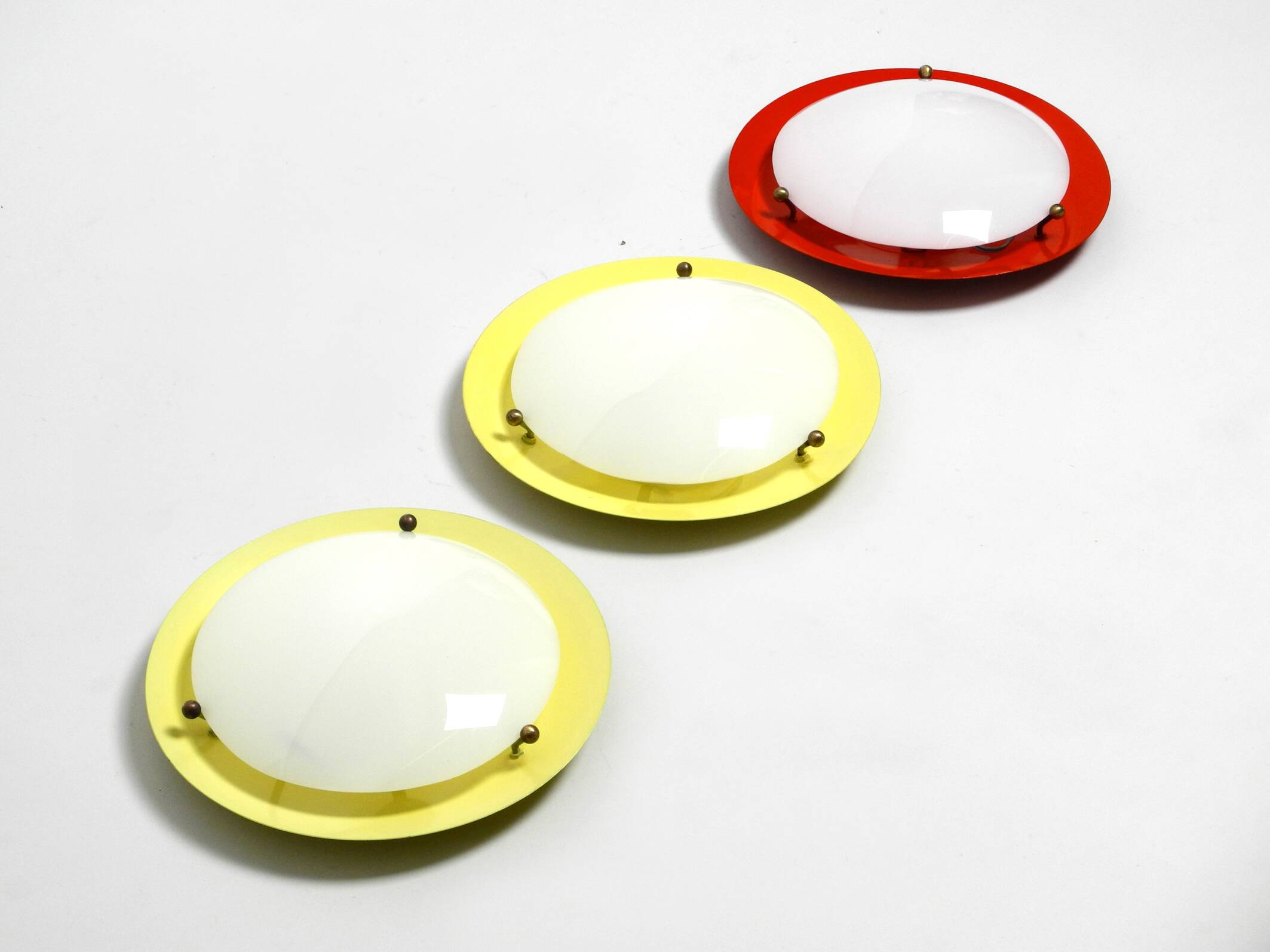Three round 1950s wall or ceiling lamps made of metal and plexiglass shades