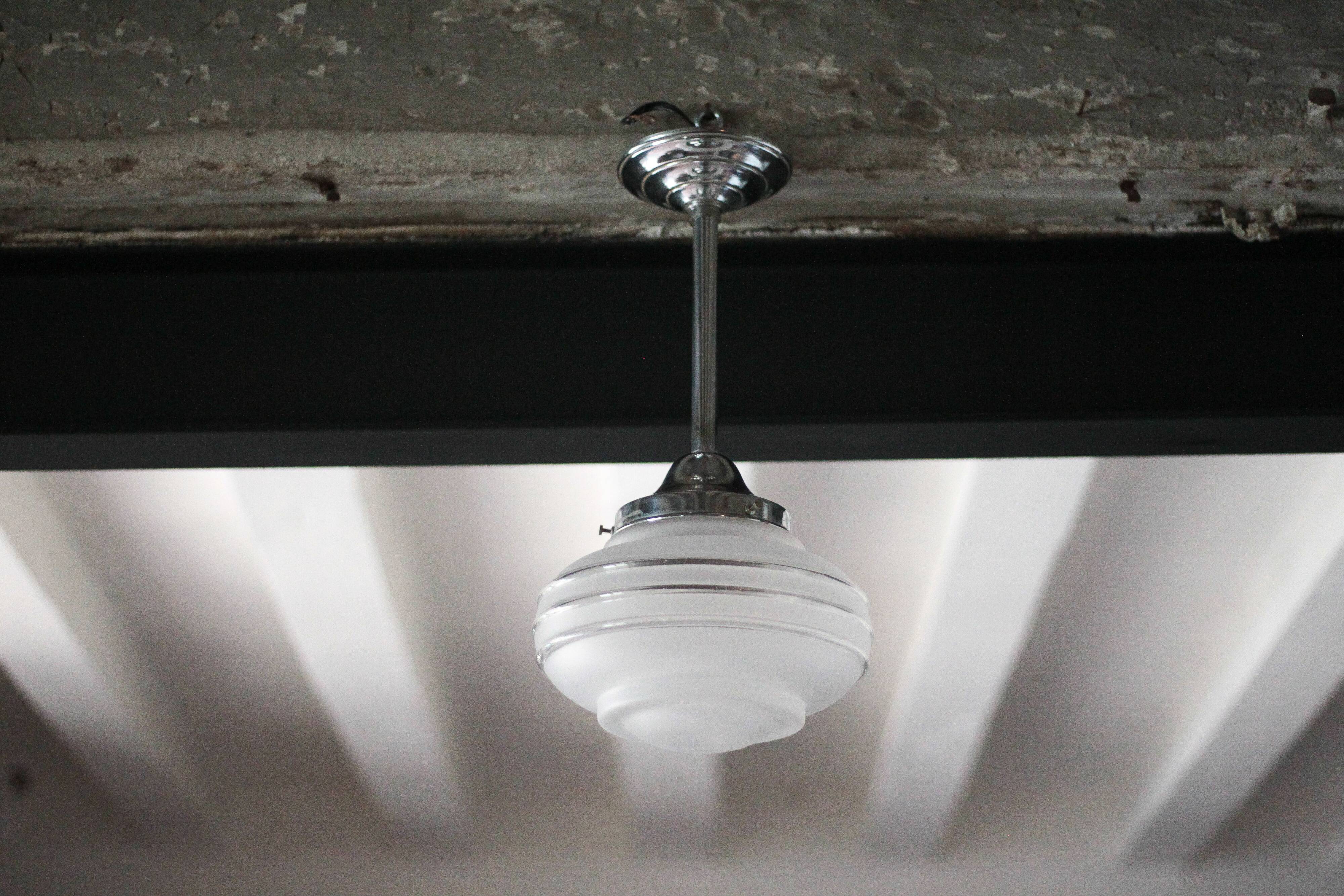 Art Deco pendant light, chrome metal suspension and glass globe, ceiling lamp.