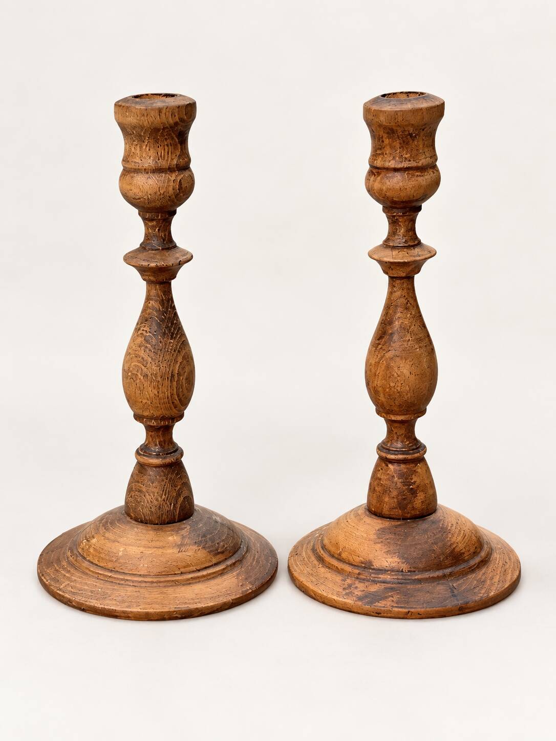 Pair of antique turned wooden candlesticks