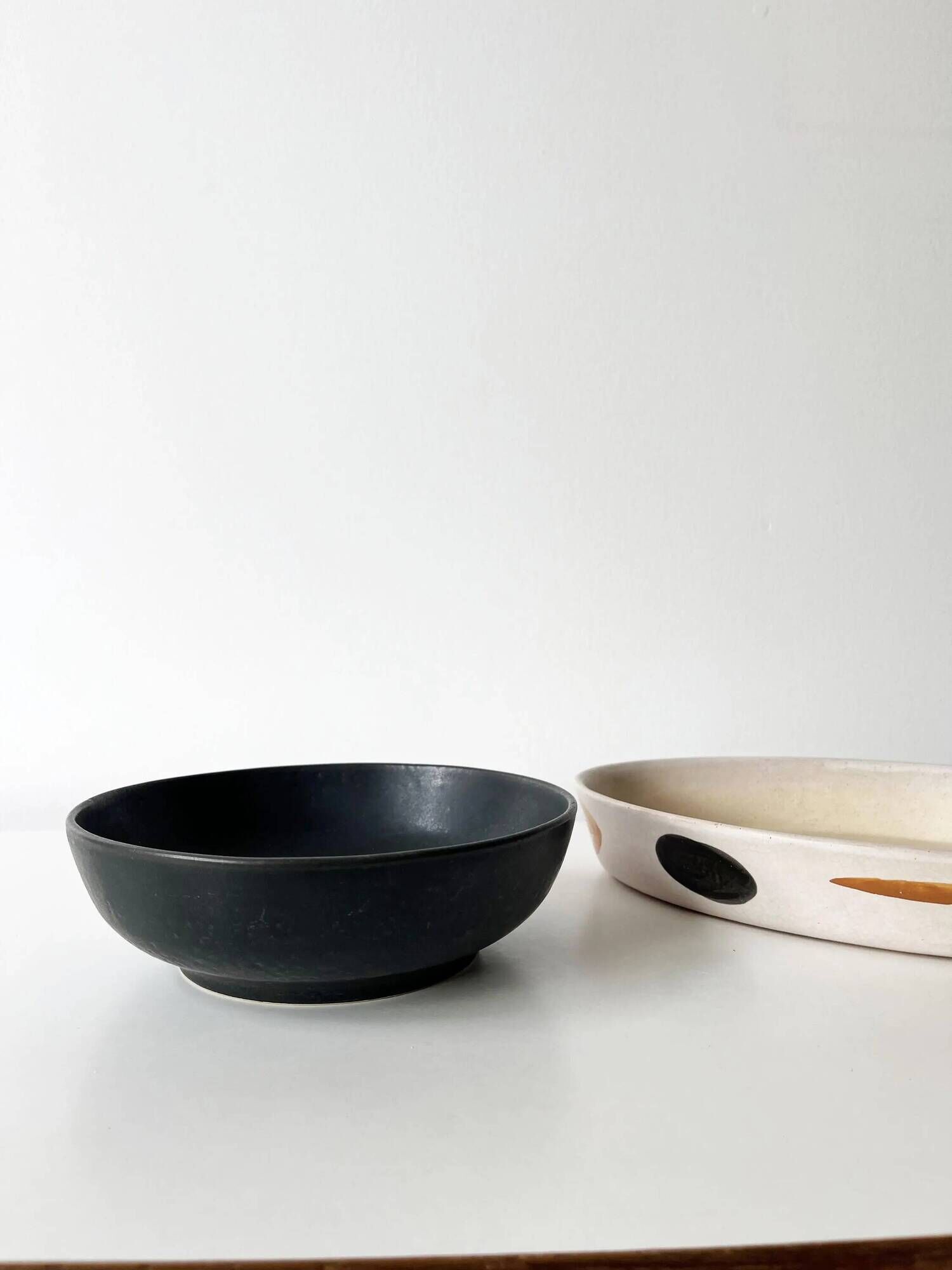 Round vintage black ceramic catchall.