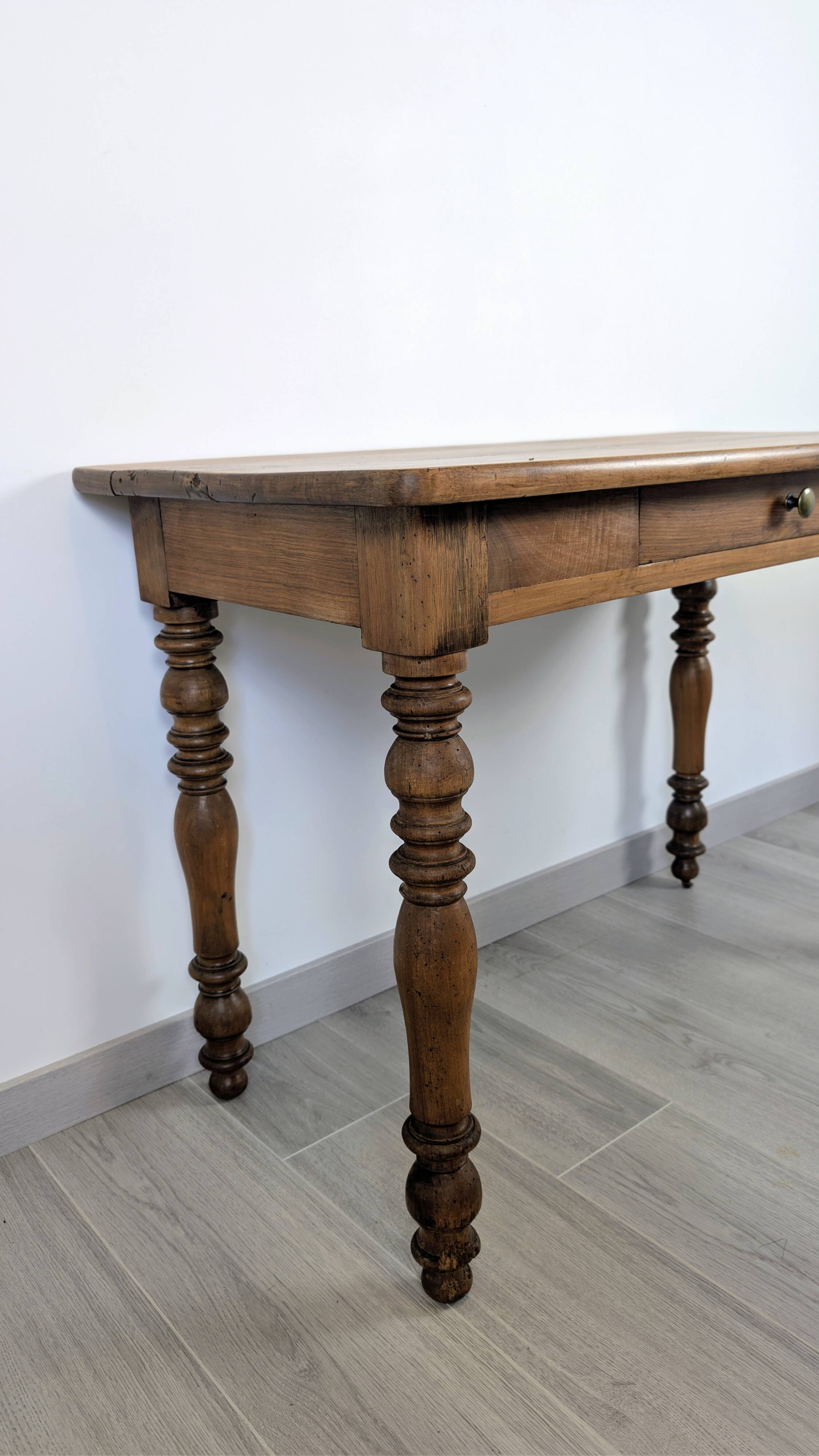 Antique writing table in the Napoleon III style with turned wooden legs.