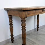 Antique writing table in the Napoleon III style with turned wooden legs.
