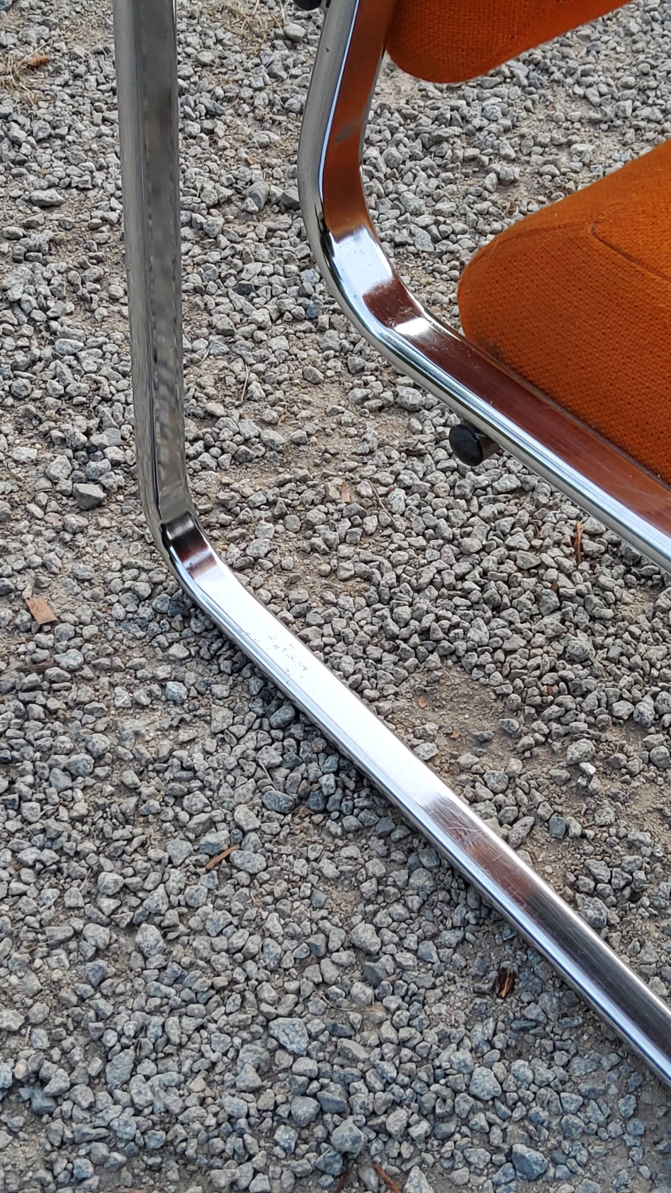 Pair of designer armchairs in orange fabrics and chrome tubes from the 70s