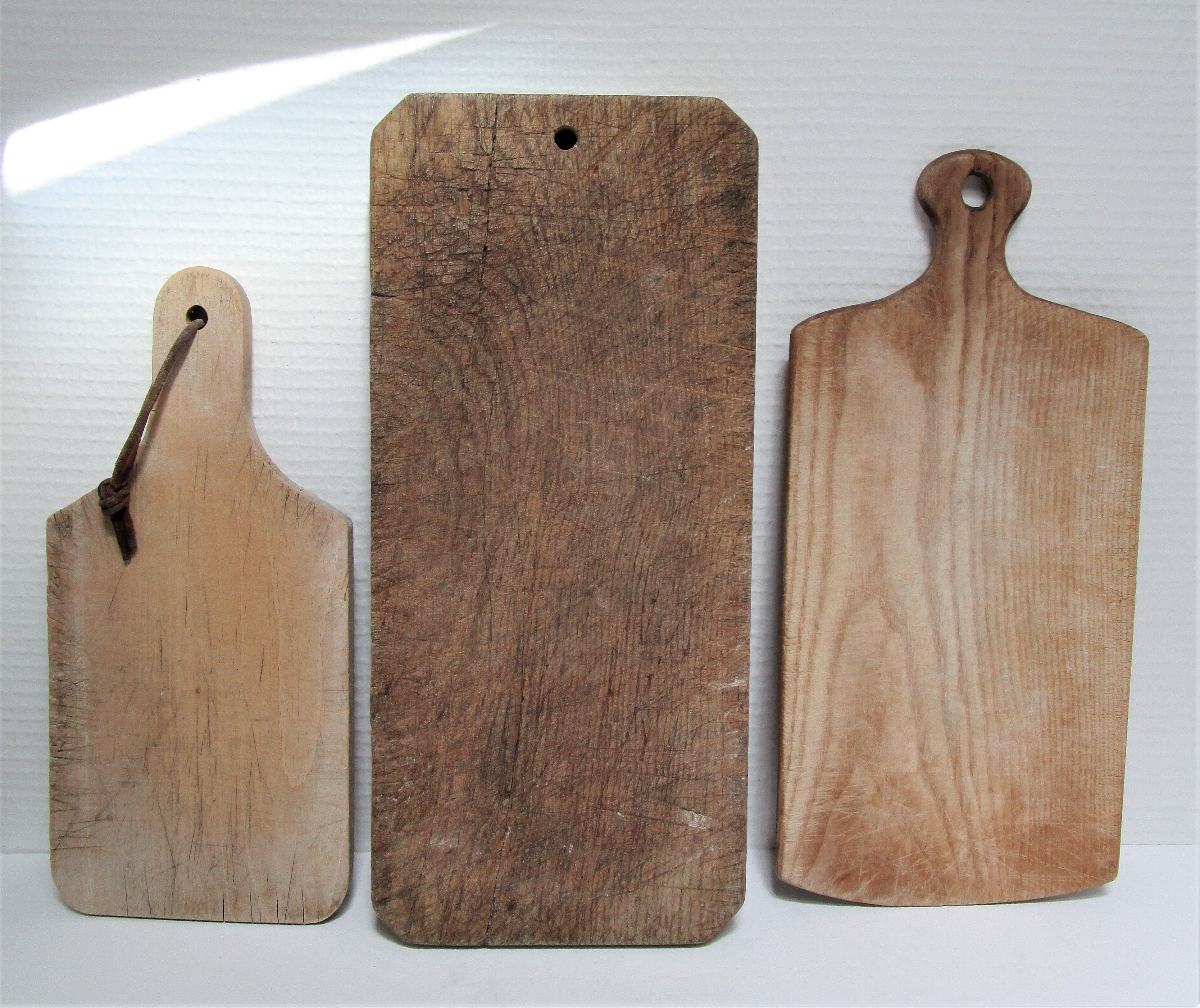 three vintage patinated solid wood cutting boards