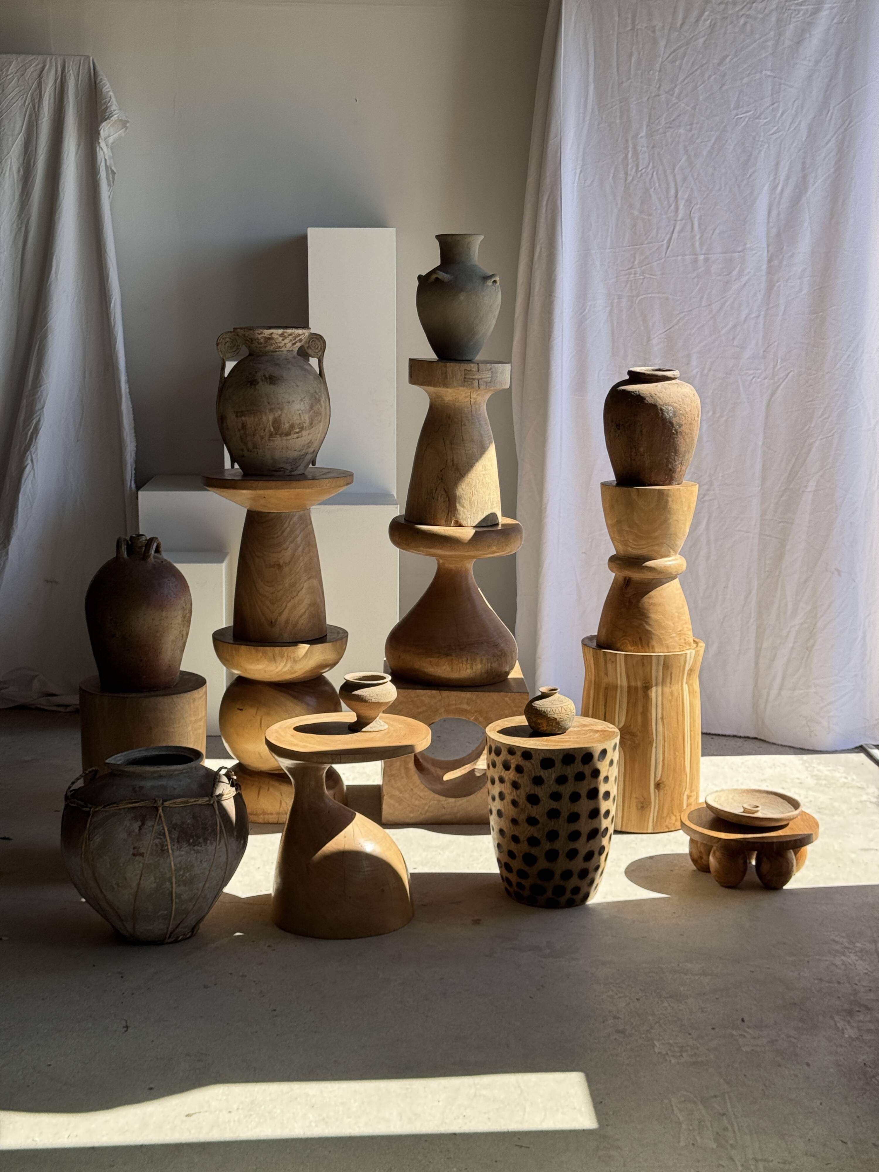 Natural solid mango side table (monoxyle) with conical legs.