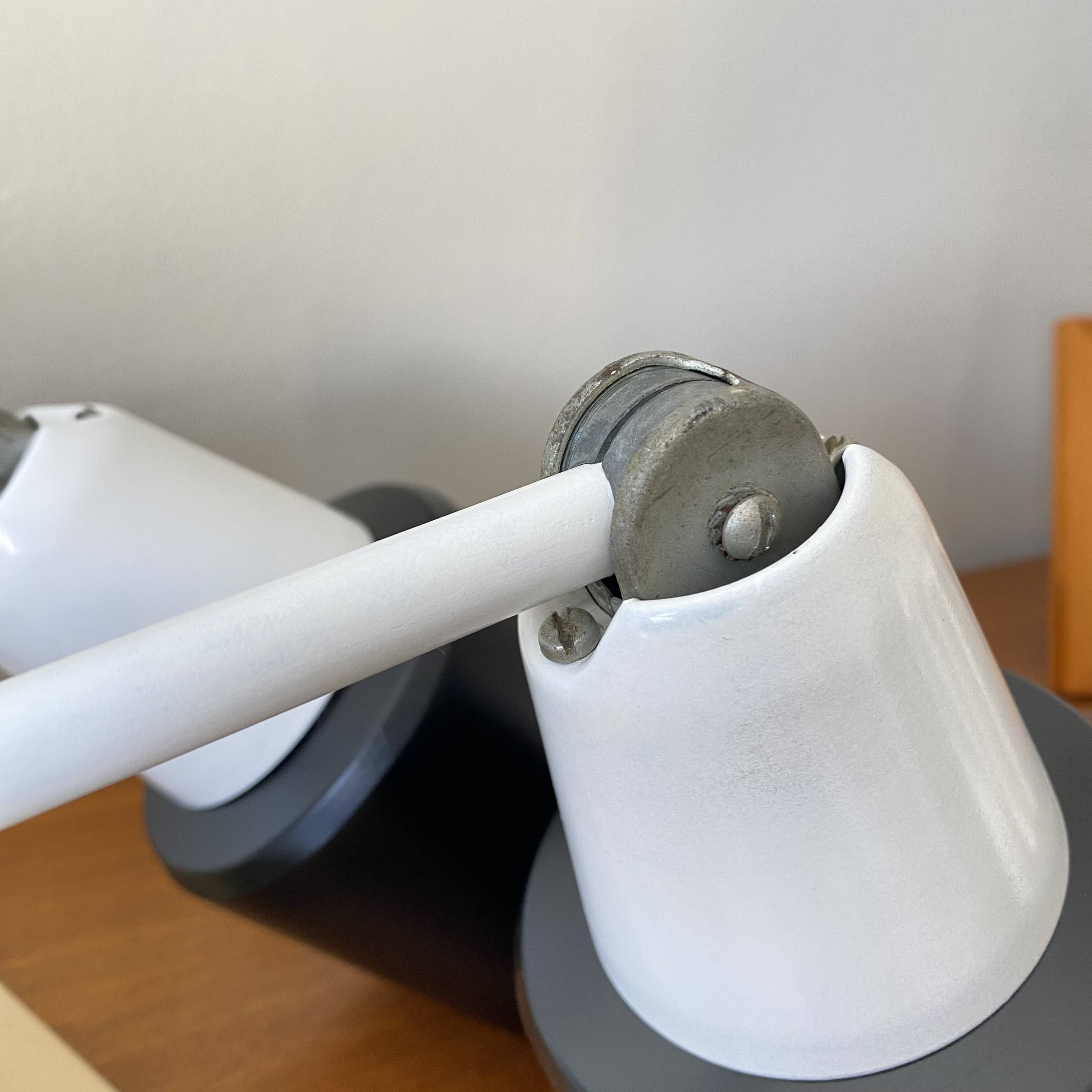 Pair of adjustable industrial metal wall sconces.