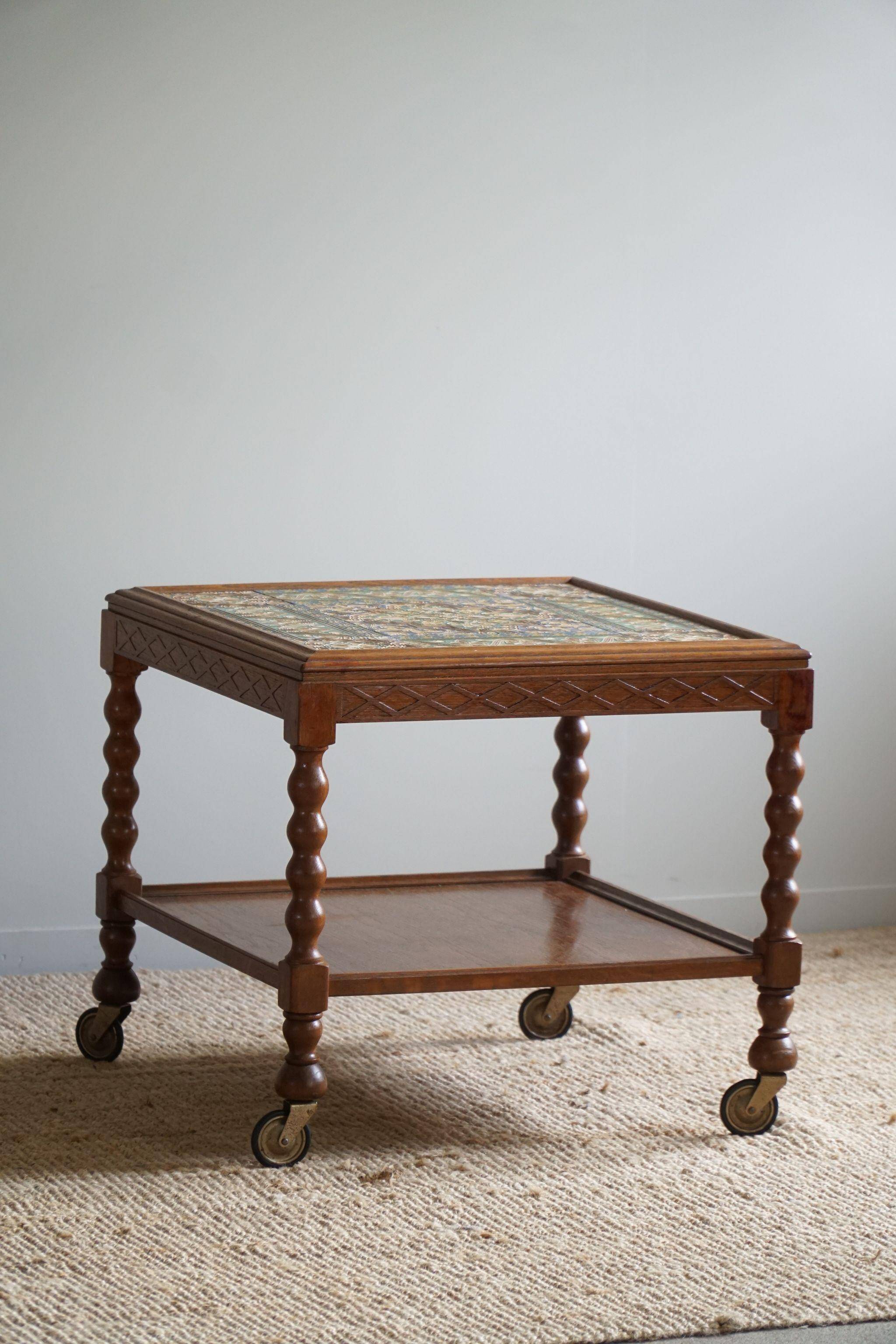 Modern Danish service table with turned spool legs and coloured tiles, 1950s.
