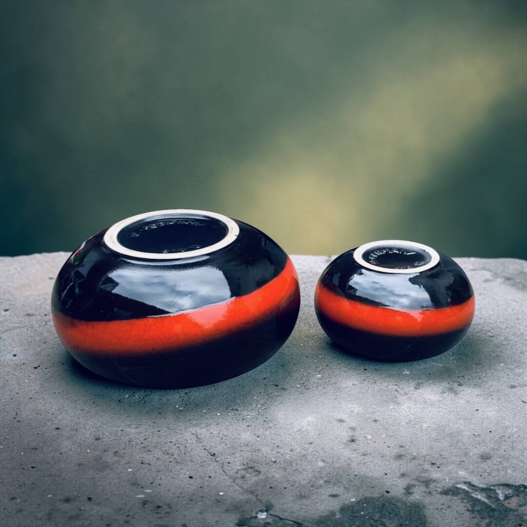 A pair of black and red spherical vases by Bay Keramik, West Germany, from the 1960s.